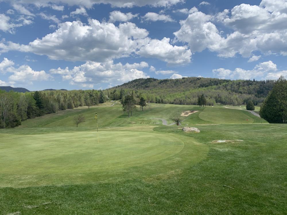 The #9 hole and the #8 green at Craig Wood Golf Club, with low mountains in the background.