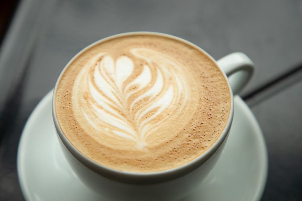 A freshly-made coffee with foam art in a white mug