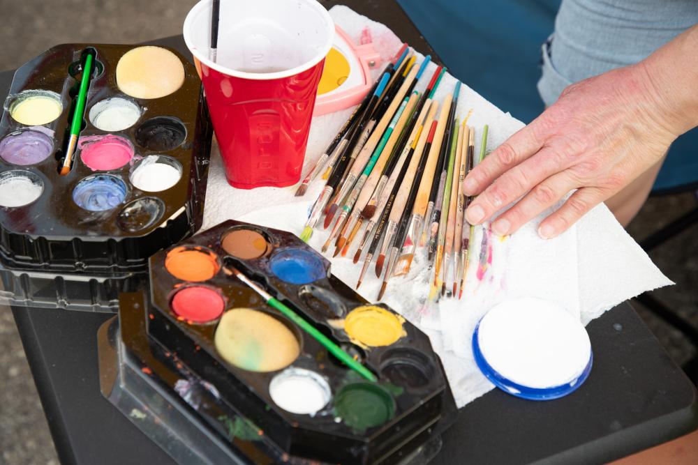 Colorful paints and brushes for an artist getting ready to work.