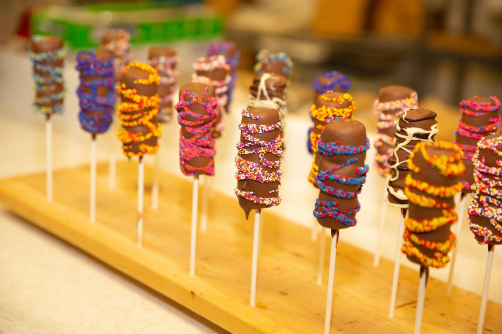 Close up of chocolate covered marshmallow lollipops.