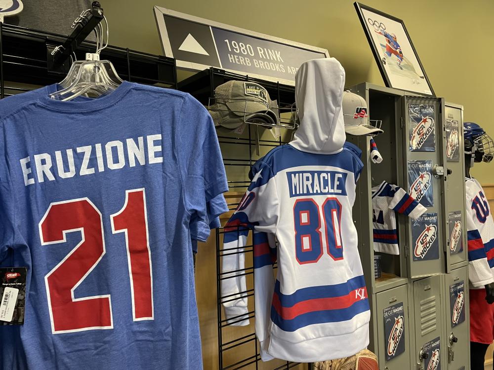 A display of tshirts, jerseys, and other hockey apparel and memorabilia in a shop.