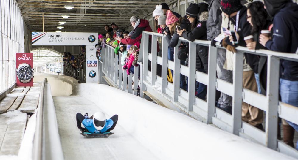 Fans spectate a skeleton sliding event