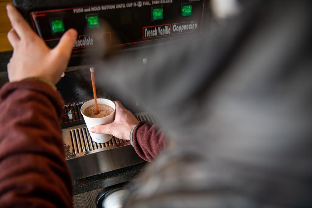 A man pours a cup of coffee.