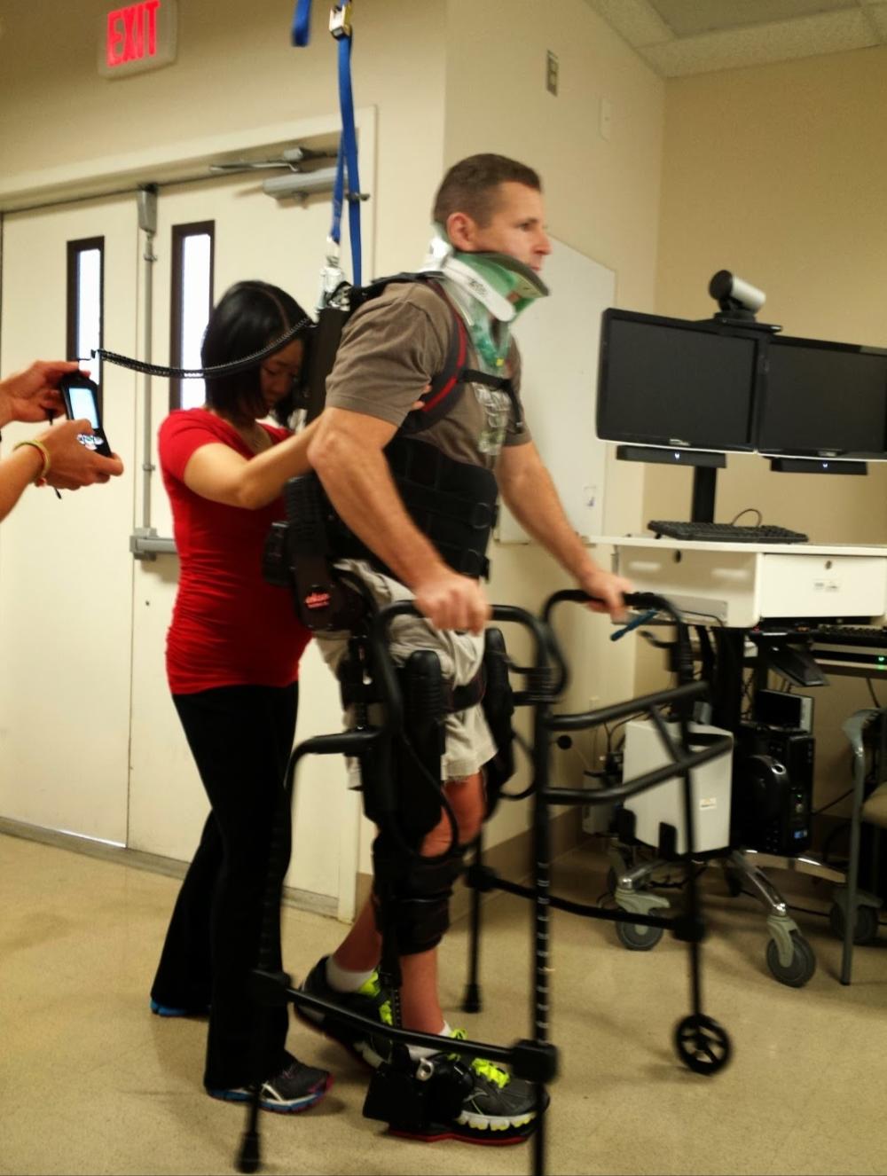 David Christopher attempts to walk with the assistance of a walker, a back brace, and a physical therapist during one of many rehabilitation sessions following his accident  A picture of David Christopher in November 2010. He was a US Army Captain with the 414th Civil Affairs Battalion as part of the United States Civil Affairs and Psychological Operations Command. Image courtesy of David Christopher.