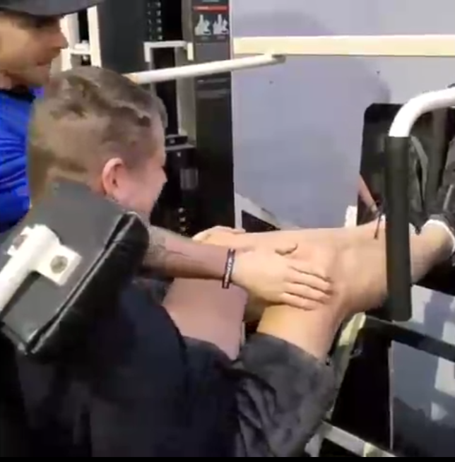 David Christopher leg pressing 40 pounds during a rehabilitation session. He is slowly regaining leg function after doctors believed he would never walk again.