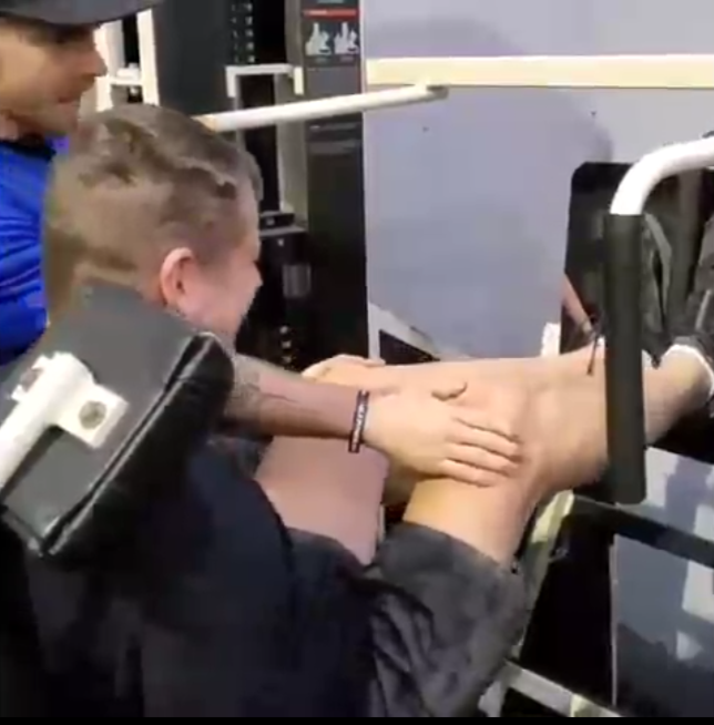 A screenshot taken from a video of David Christopher leg pressing 40 pounds during a rehabilitation session. He is slowly regaining leg function after doctors believed he would never walk again. Video courtesy of David Christopher David Christopher leg pressing 40 pounds during a rehabilitation session. He is slowly regaining leg function after doctors believed he would never walk again.
