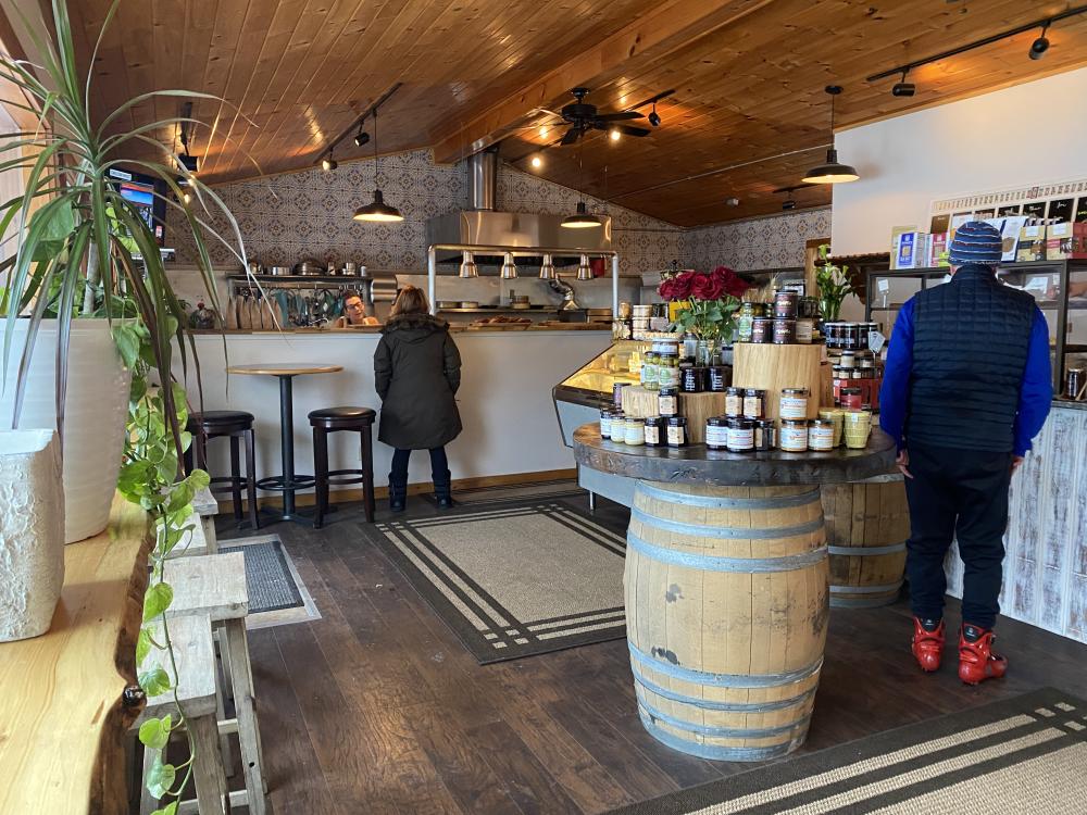 Two people wander around the shop as Dan and Rene bake behind the counter