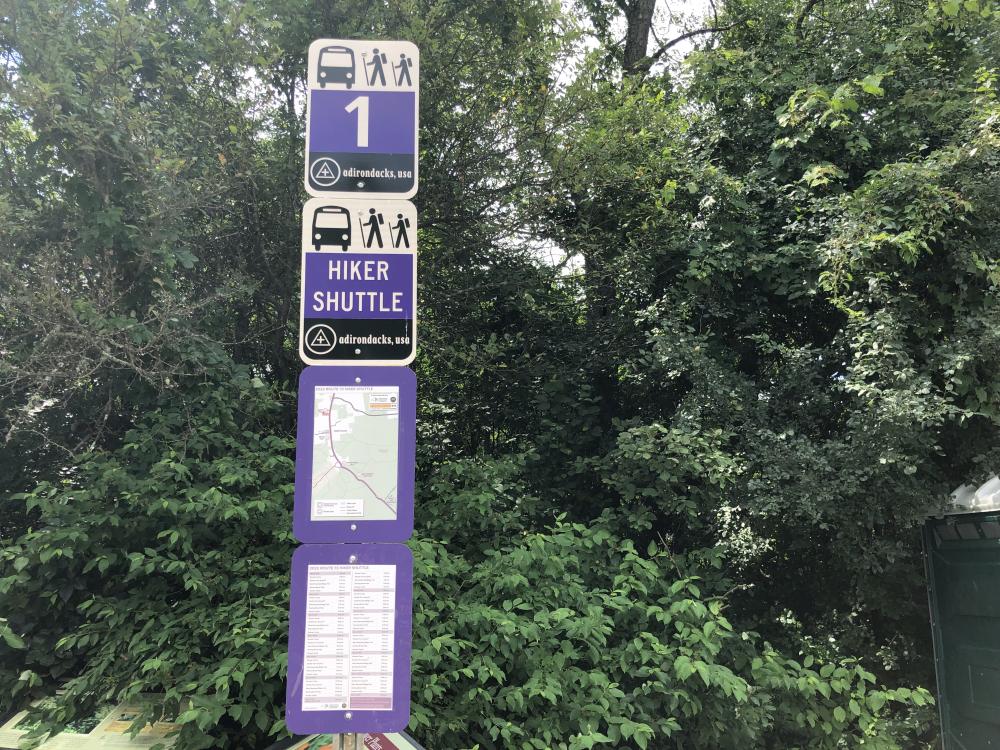 The hiking shuttle signs at Marcy Field