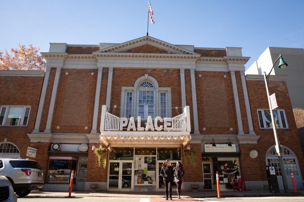 The exterior of a classic movie theater with brick facade and old-fashioned marquee.