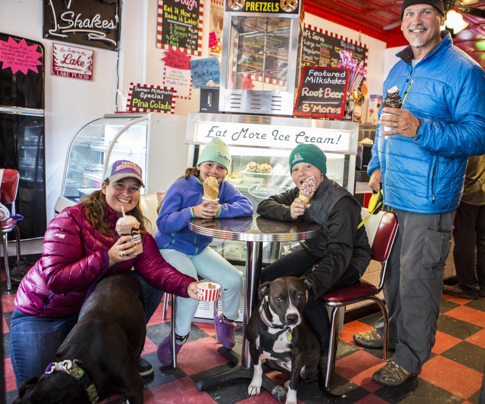 family of four enjoying different desserts