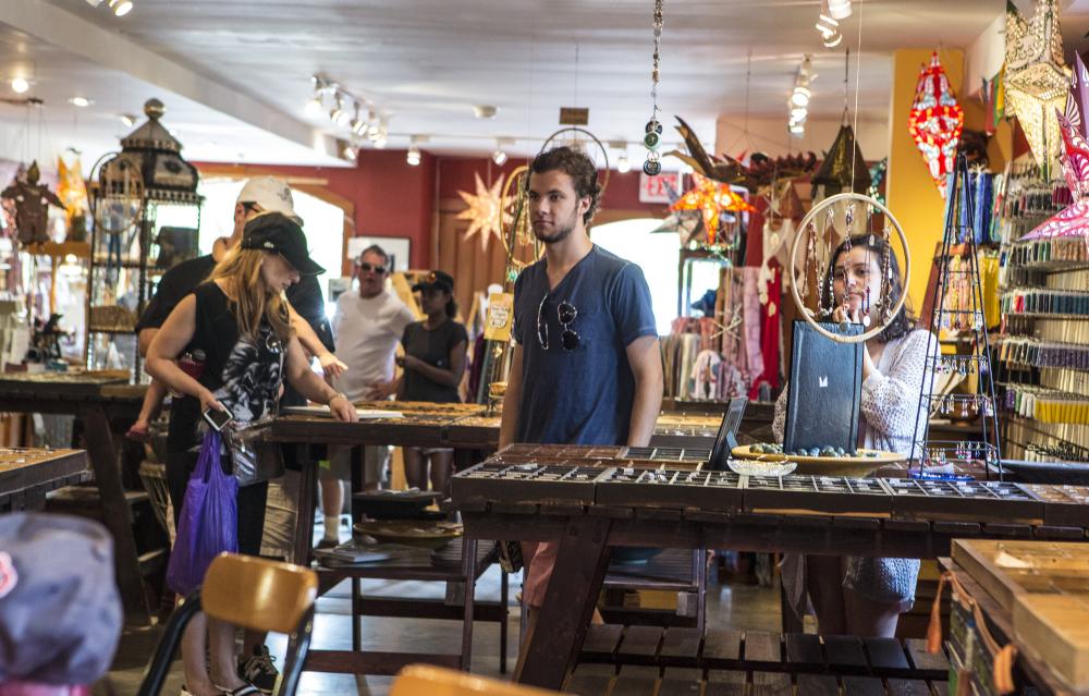 A colorfully decorated bead shop bustles with shoppers.