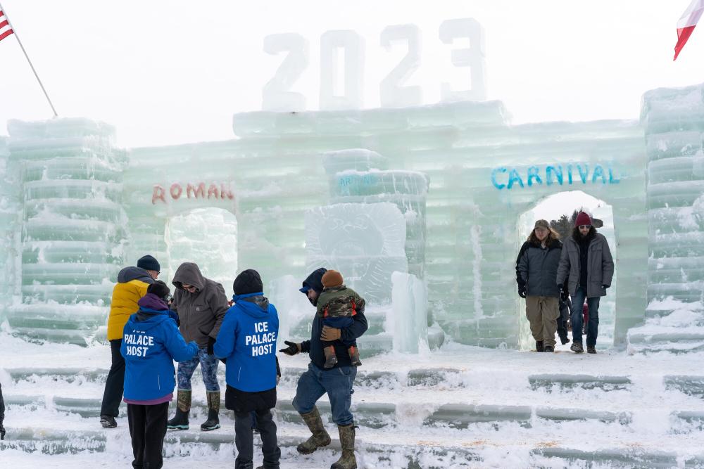 people walking around the ice castle