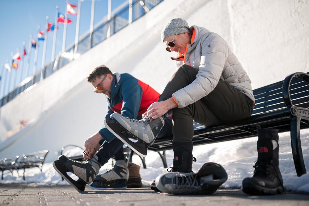 two friends lacing up skates to play outside.