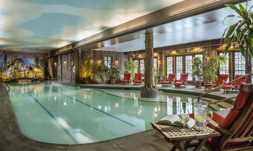 Photo courtesy of Mirror Lake Inn Resort and Spa A view of the indoor pool at the Mirror Lake Inn Resort and Spa, with lounge chairs lining the edges of the pool walkway