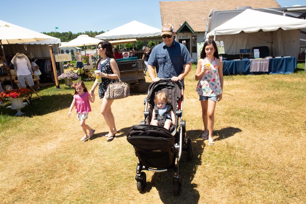 A family strolls together at the Lake Placid Horse Show grounds