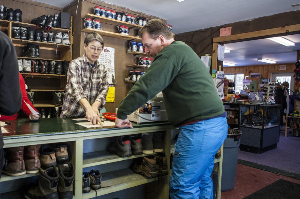 A man buys used gear at the welcome center.