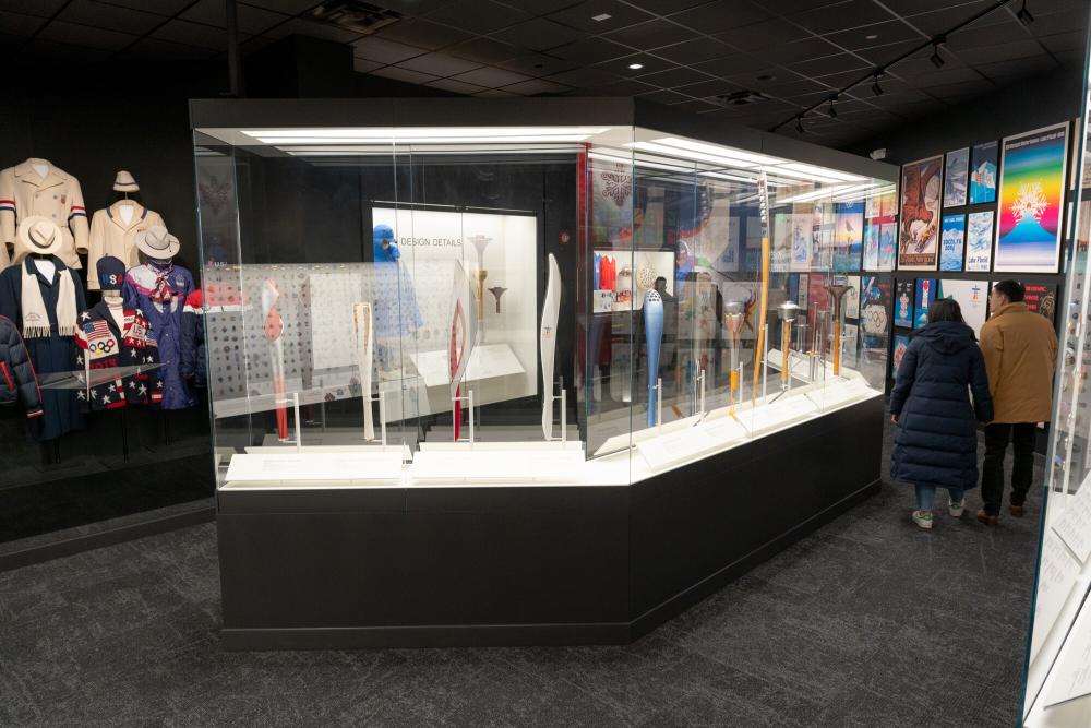 A glass case filled with Olympic memorabilia in a museum