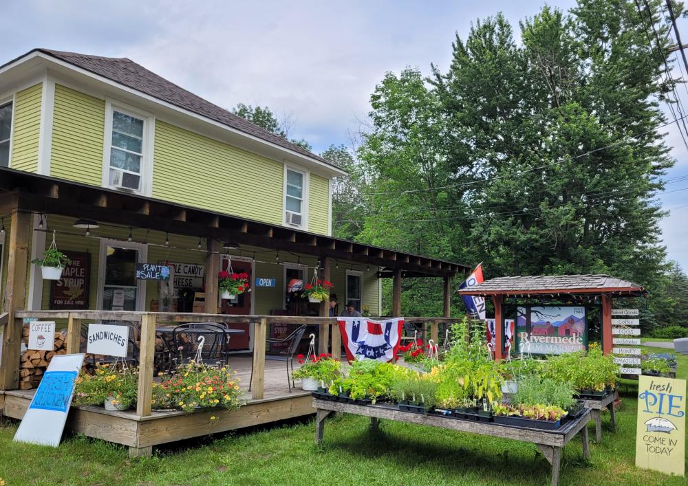 Rivermede Farm Market Rivermede Farm Market is a yellow building with a big front porch. Two men and their dog are on the front porch