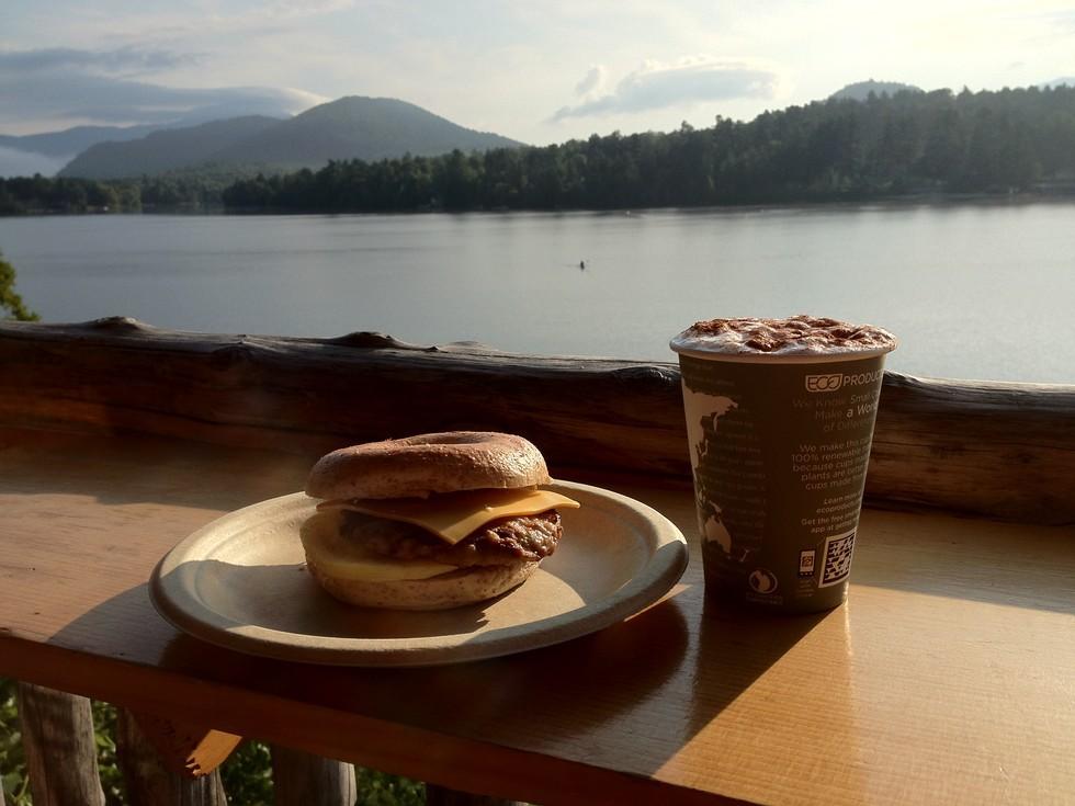 A breakfast sandwich and coffee overlook Mirror Lake.