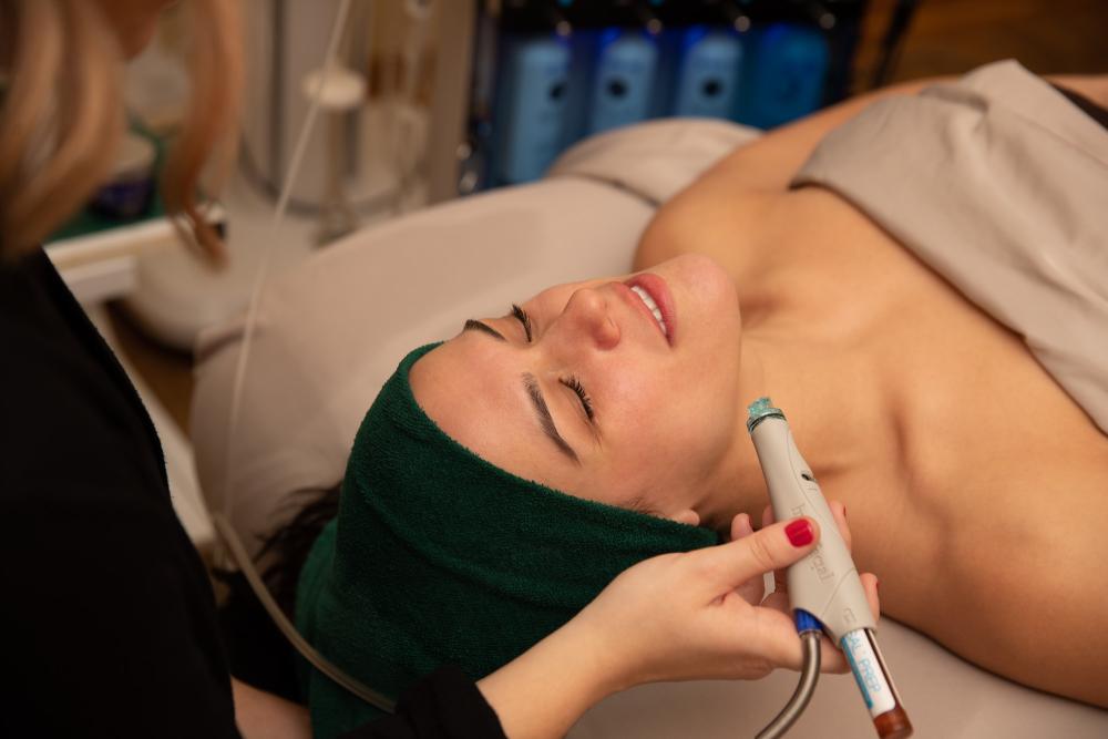 A woman gets a facial from a spa.