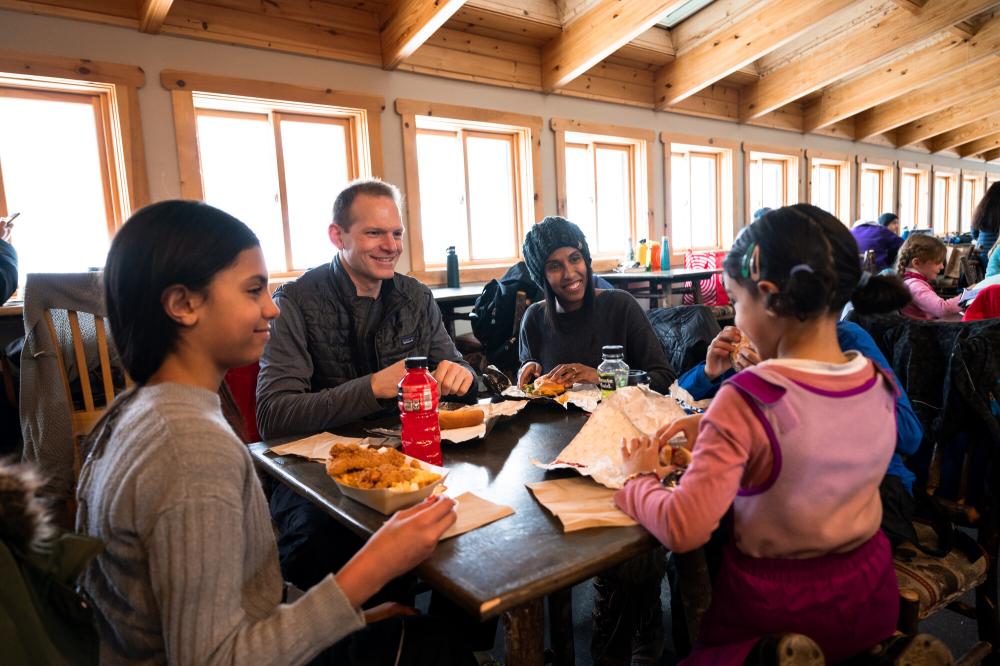 A family eats at a ski mountain lodge