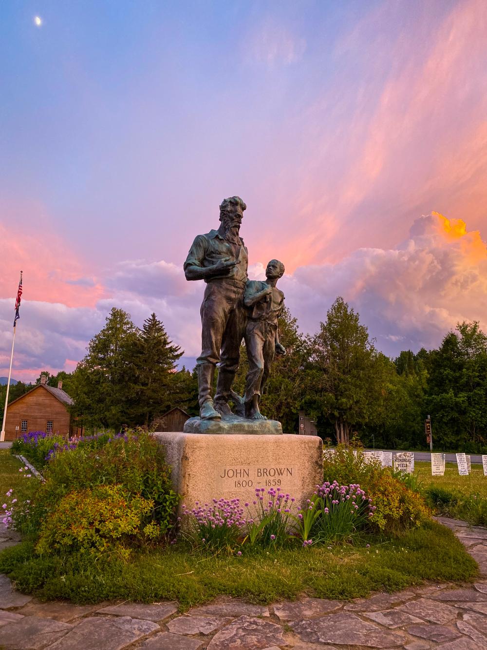 A statue of a man and child at John Brown Farm Historic site.
