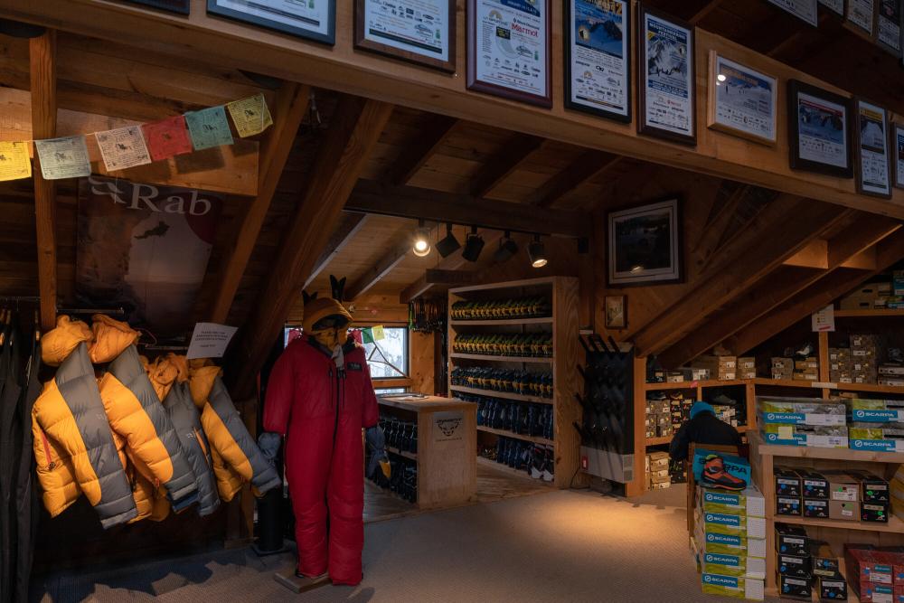 Puffy jackets in a wooden-paneled gear shop