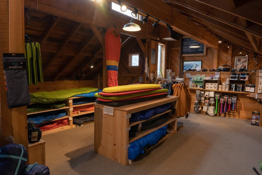 A table of sleeping gear in a gear shop