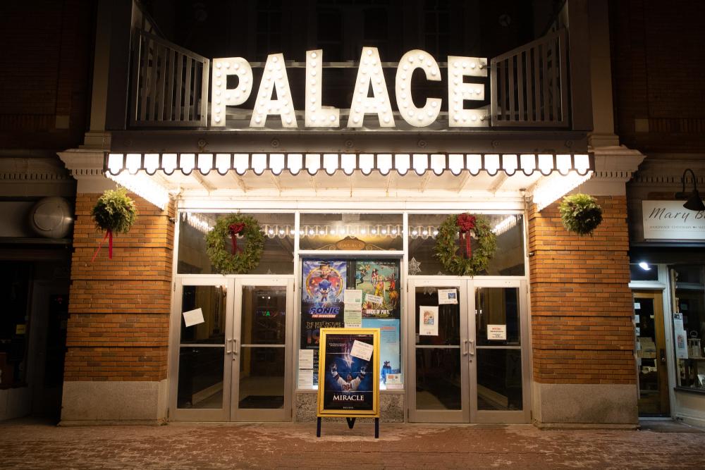 Outdoor lighting illuminates the historic Palace Theater in Lake Placid after dark