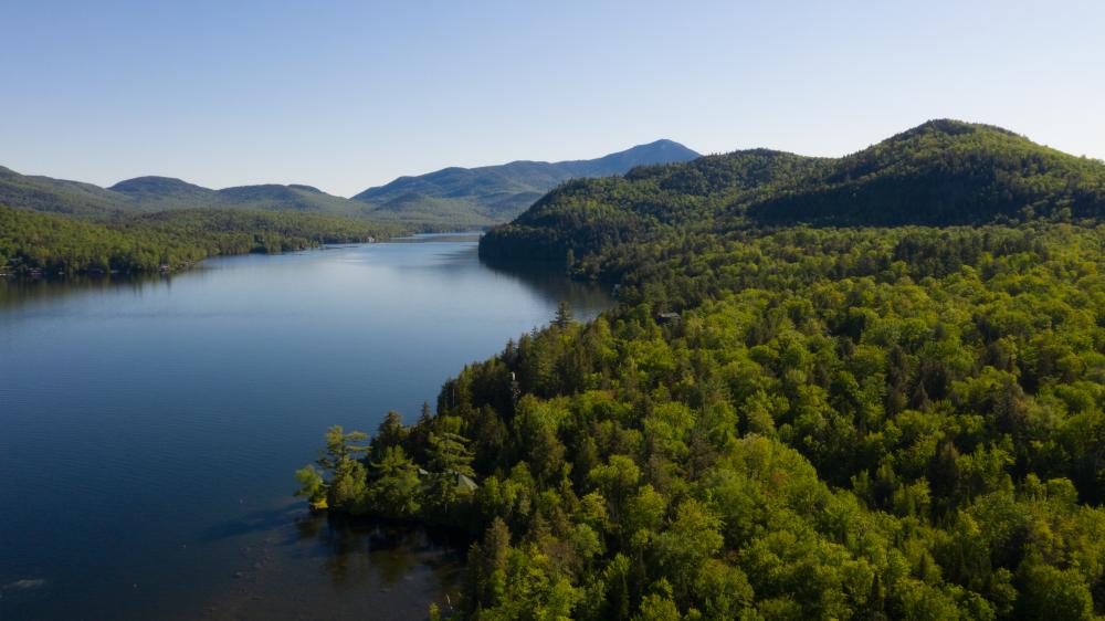 An Aerial view of Lake Placid, surrounded by forests.