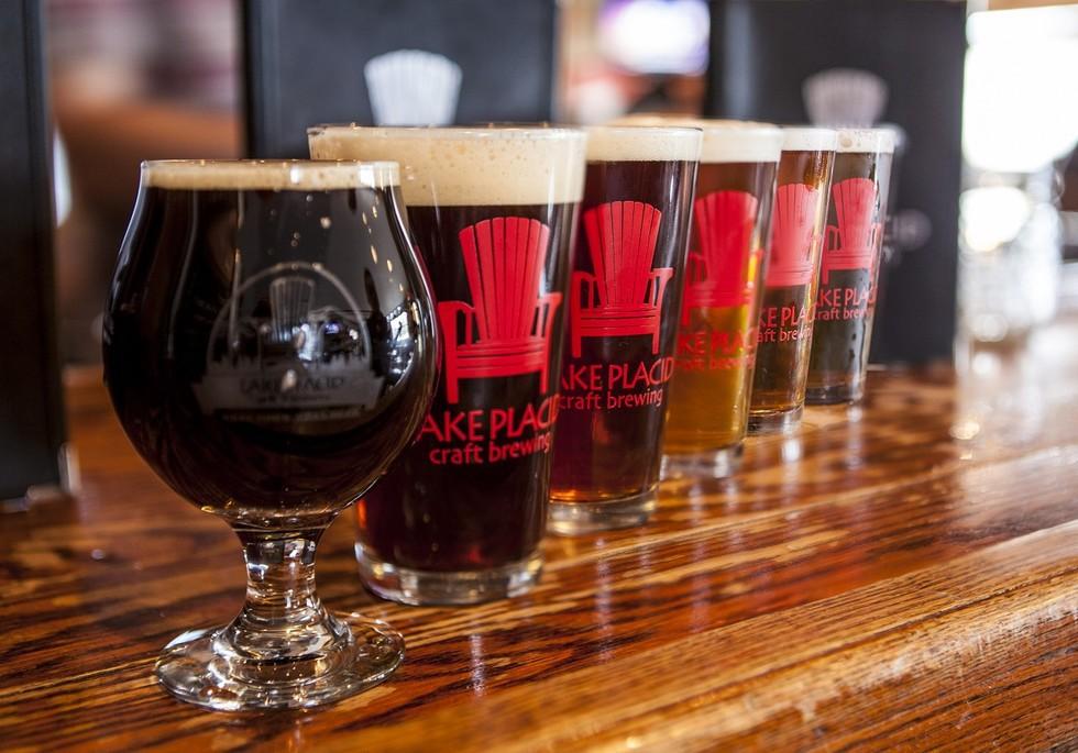 A line of glass cups with "Lake Placid Craft Brewing" printed on the side.