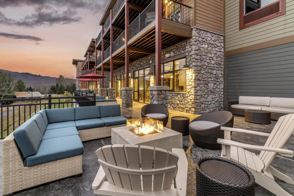 The stylish exterior deck with lounge furniture at a hotel.