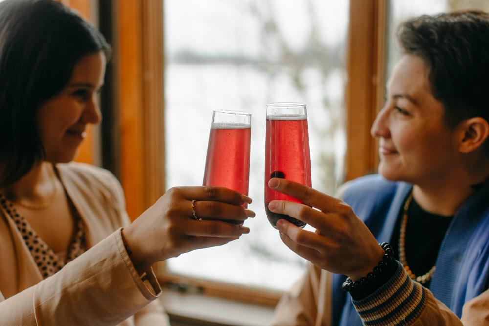 Mimosas at Breakfast Club, Inc Two women cheers pink mimosas