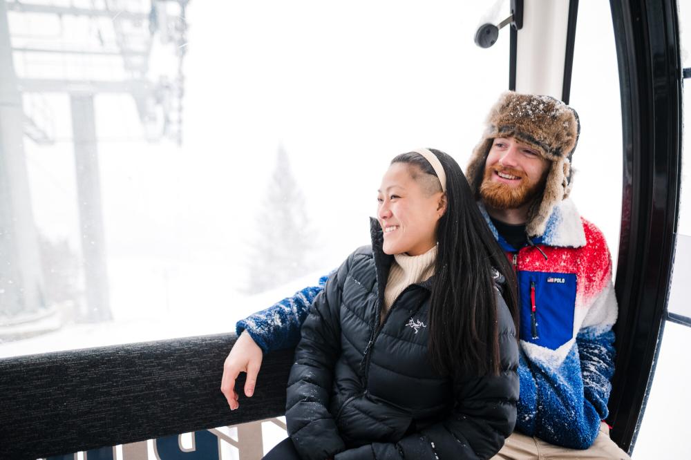 Skyride Gondola at Olympic Ski Jumps Woman leans against man riding in glass gondola