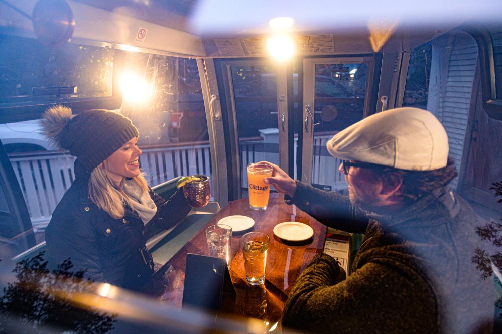 Gondola dining at The Cottage Man and woman inside gondola eating dinner