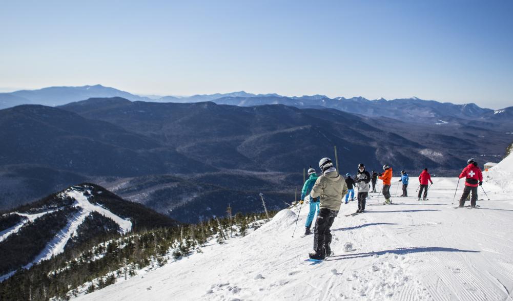 a group of skiers stop on the side of Whiteface to take in the view.