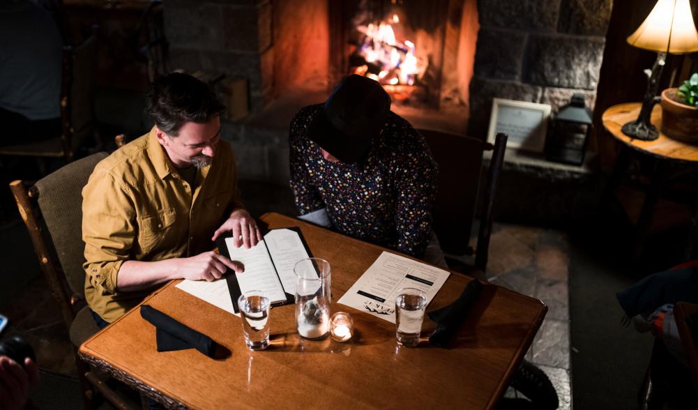 Two people order food by the fire