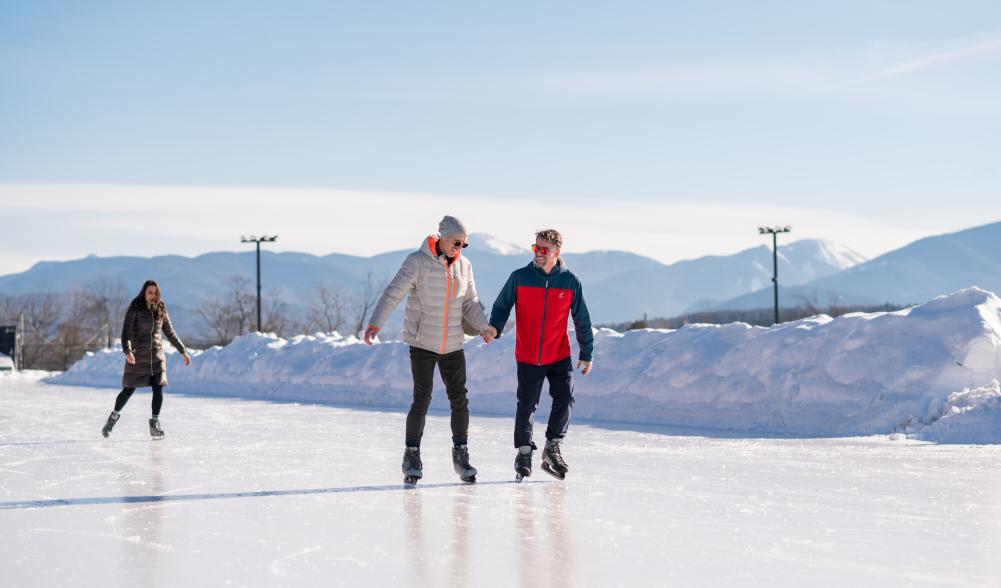 A couple skates on a scenic oval