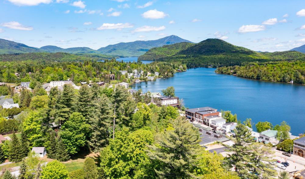 downtown lake placid in summer with whiteface mountain in the background.