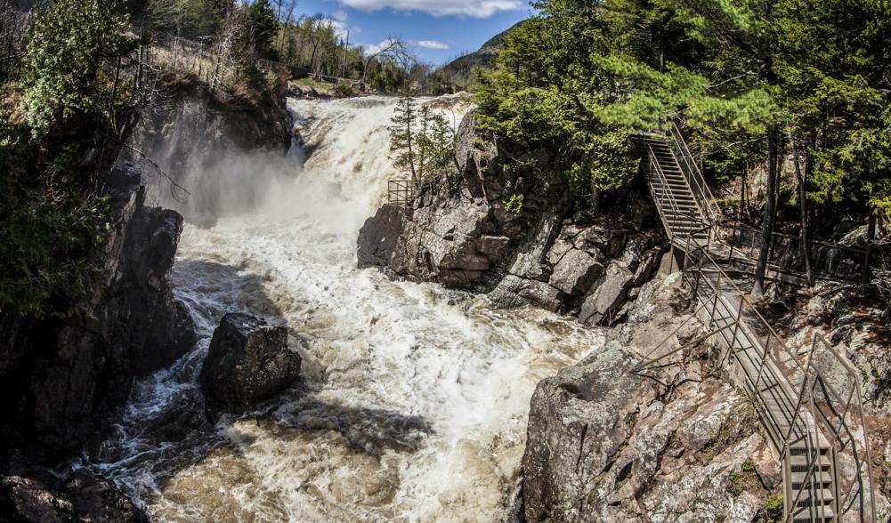 Walkway heading towards a waterfall along the Au Sable River at High Falls Gorge