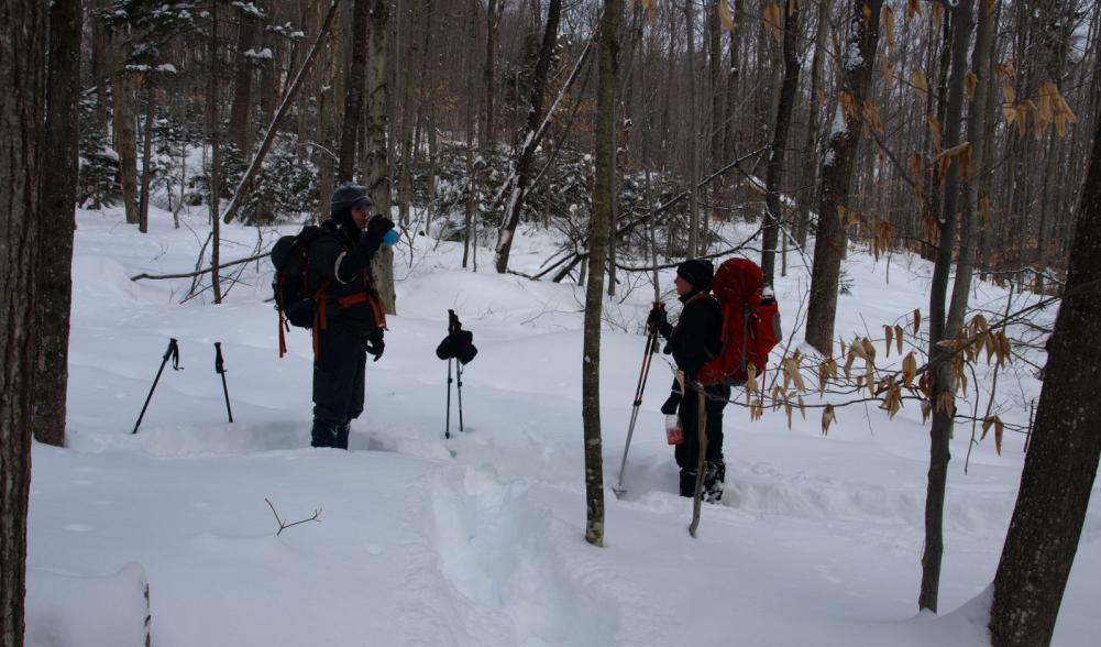 A quick break and grabbing some fluids on a demanding part of the hike