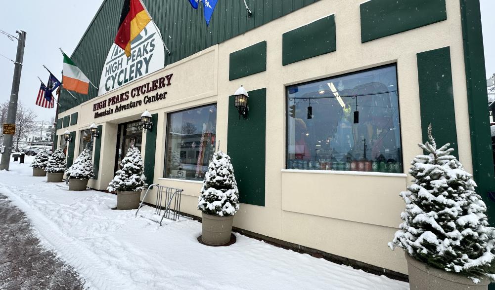 The front of High Peaks Cyclery covered in freshly fallen snow