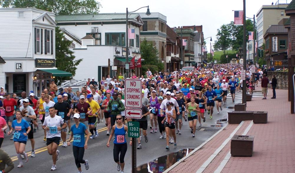 Runners in the Lake Placid Marathon engulf Main Street at the beginning of the race