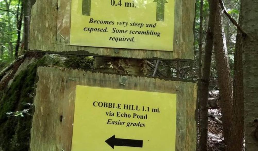 Signs directing you to two different approaches to the summit of Cobble Hill