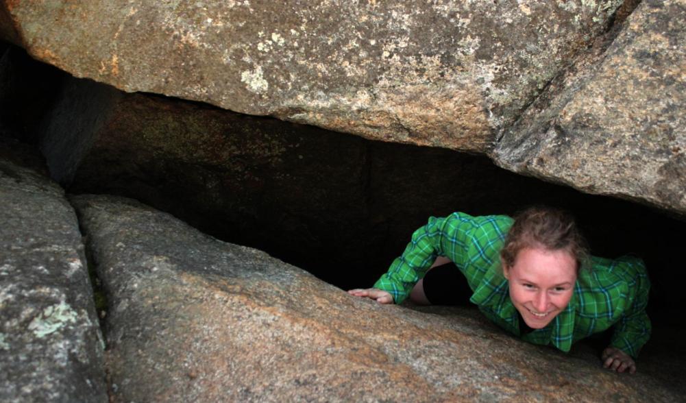 Emilee exits the cave-like crack in the ledge.