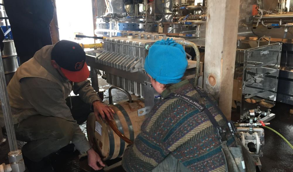 Kirk and Lizzie arranging the bourbon aged barrel.