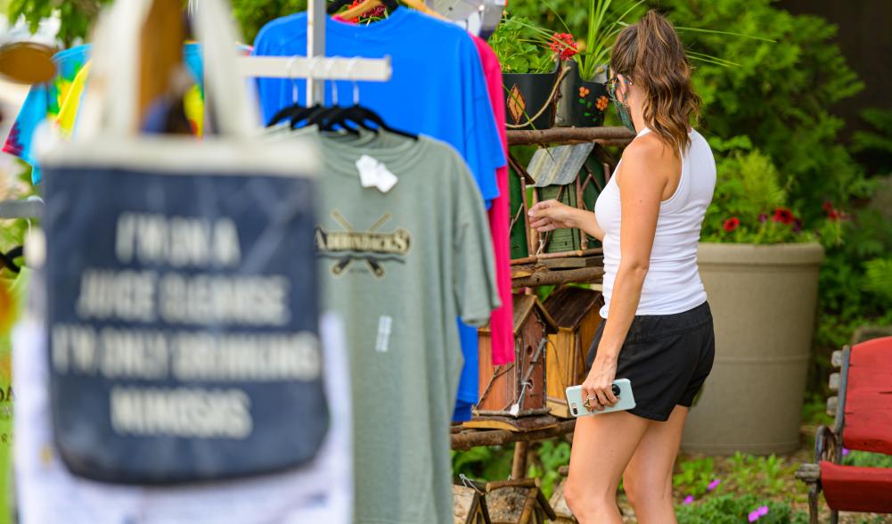 A woman browses offerings on Placid's bustling Main Street.