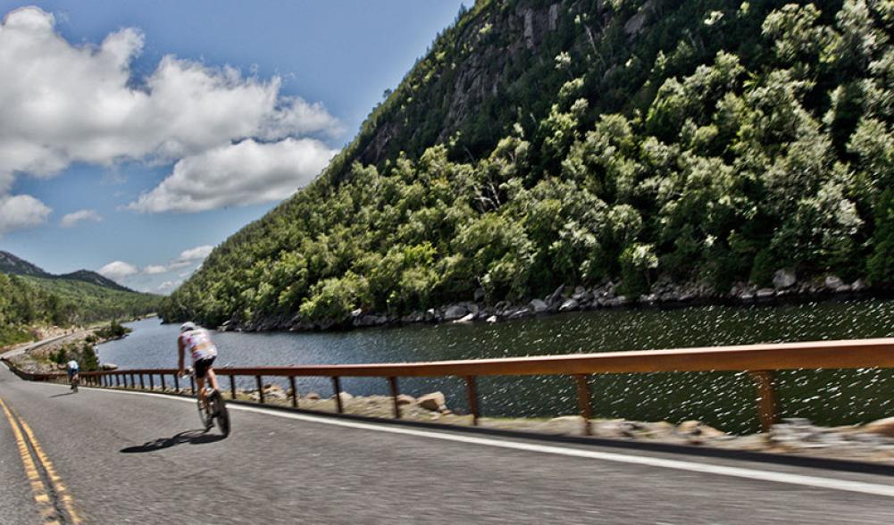 A cyclist rides past Lower Cascade Lake.