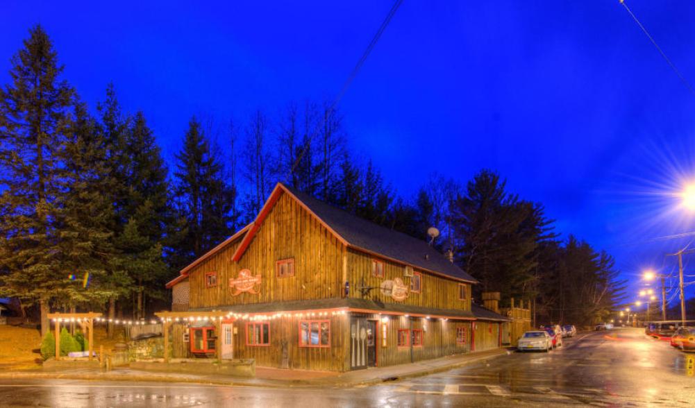 Liquids and Solids restaurant with its lights shining upon Sentinel Road at night