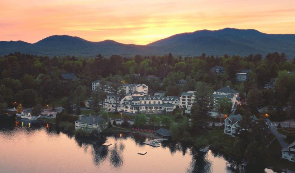 Wide aerial view of the Mirror Lake Inn's numerous buildings overlooking Mirror Lake. Image courtesy Mirror Lake Inn.